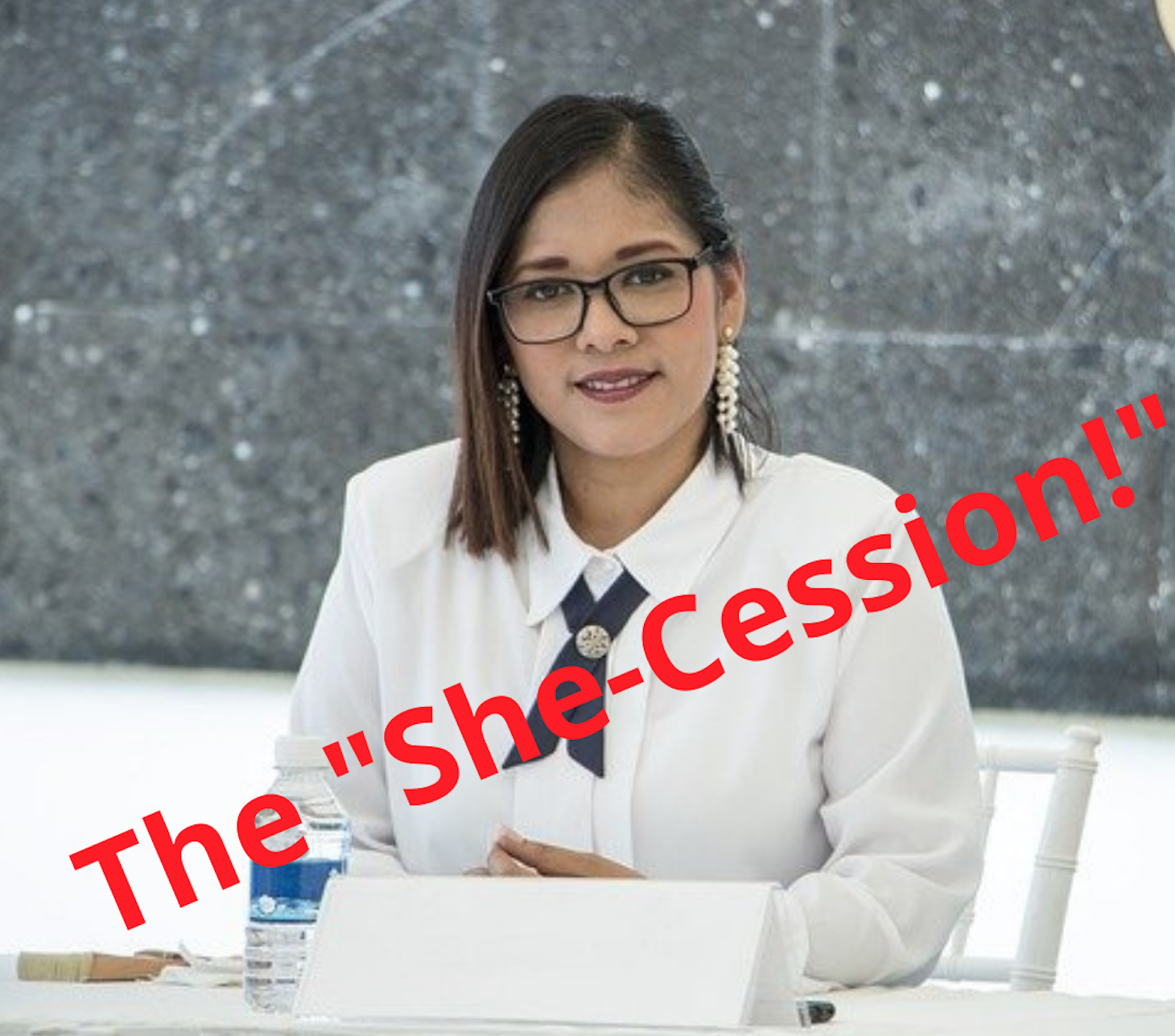 Image of a woman, likely Hispanic, in business attire with the word in red across the image saying "She-Cession"